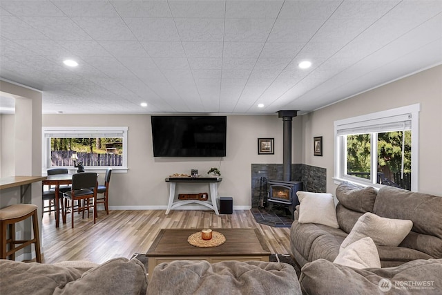 2376 Forest View Dr, Bellingham, WA 98229 - living area featuring recessed lighting, a wood stove, plenty of natural light, and wood finished floors