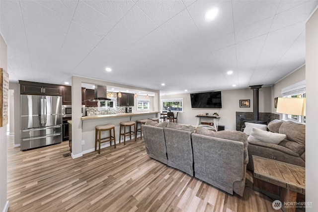 2376 Forest View Dr, Bellingham, WA 98229 - living area featuring a wood stove, light wood finished floors, and recessed lighting