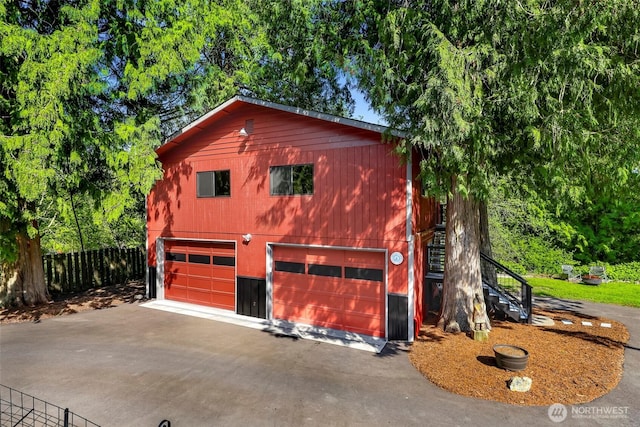 2376 Forest View Dr, Bellingham, WA 98229 - view of side of home with stairway, concrete driveway, and an attached garage