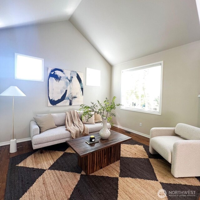 living room with baseboards, wood finished floors, and high vaulted ceiling