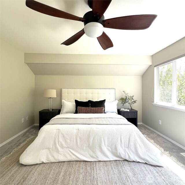 carpeted bedroom featuring baseboards, a ceiling fan, and lofted ceiling