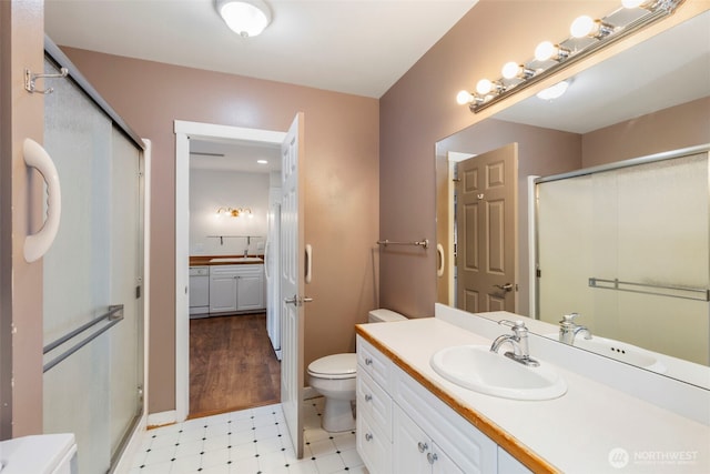 350 Castellano Way Unit 204, Port Townsend, WA 98368 - bathroom with a stall shower, tile patterned floors, vanity, and toilet