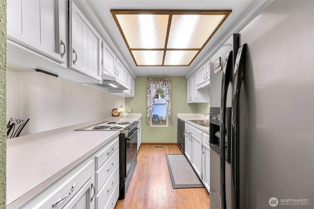 kitchen with light countertops, stainless steel fridge, dishwasher, and electric range