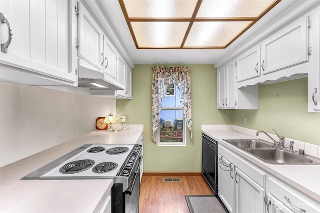 kitchen featuring a sink, light wood-style floors, range with electric cooktop, white cabinetry, and black dishwasher
