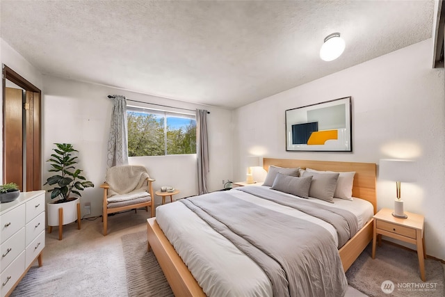 bedroom featuring a textured ceiling and light colored carpet