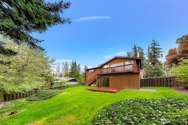 back of house with a wooden deck, a yard, a fenced backyard, and stairway