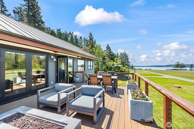 335 Blakely Dr, Blakely Island, WA 98222 - wooden terrace featuring outdoor dining space, a water view, a yard, and french doors
