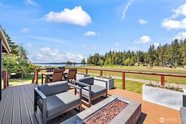 335 Blakely Dr, Blakely Island, WA 98222 - wooden terrace featuring an outdoor living space with a fire pit, outdoor dining area, a yard, and a water view