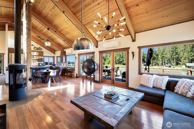 335 Blakely Dr, Blakely Island, WA 98222 - living room featuring wood ceiling with exposed beams, a wall mounted AC, hardwood / wood-style flooring, high vaulted ceiling, and baseboards