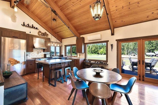 335 Blakely Dr, Blakely Island, WA 98222 - dining room featuring a wall unit AC, light wood-type flooring, french doors, wooden ceiling, and a chandelier