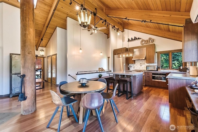335 Blakely Dr, Blakely Island, WA 98222 - dining room featuring wooden ceiling with exposed beams, wood-type flooring, high vaulted ceiling, ceiling fan, and a chandelier
