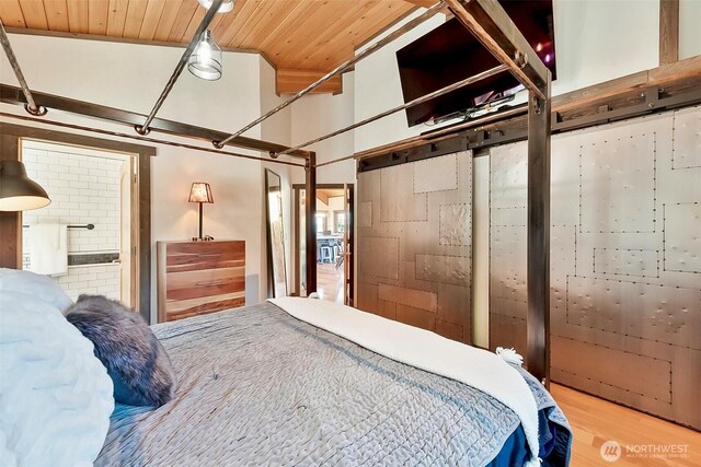 335 Blakely Dr, Blakely Island, WA 98222 - bedroom featuring wood finished floors, wood ceiling, and ensuite bath
