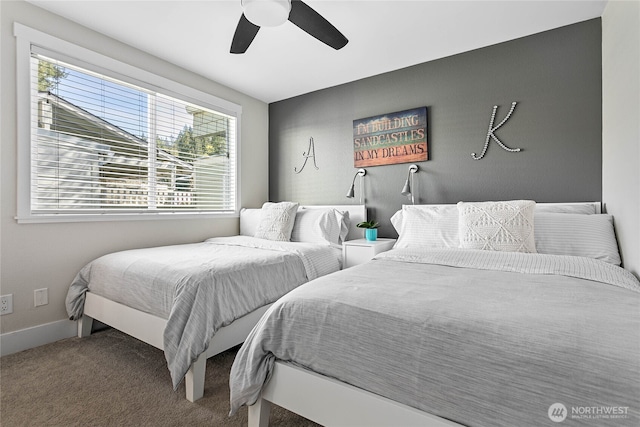 carpeted bedroom with baseboards and ceiling fan