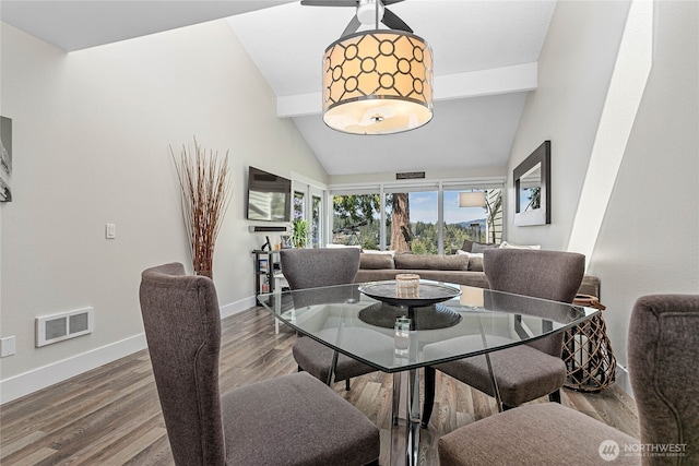 dining area with a ceiling fan, visible vents, wood finished floors, baseboards, and beamed ceiling
