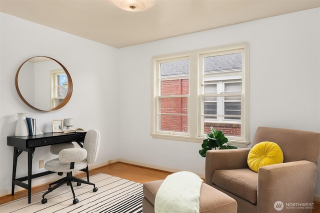 office area with baseboards and wood finished floors