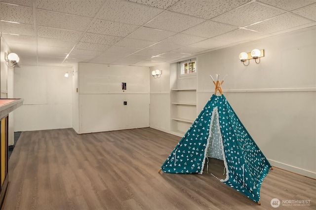 playroom featuring a drop ceiling and wood finished floors