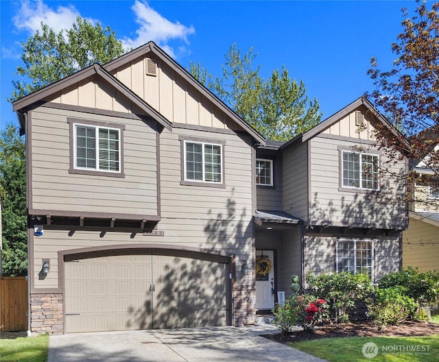 19301 87th Avenue Ct E, Graham, WA 98375 - view of front of house featuring a garage, driveway, board and batten siding, and stone siding