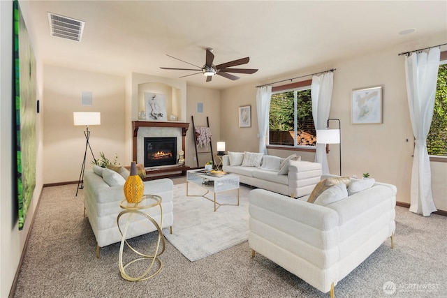 19301 87th Avenue Ct E, Graham, WA 98375 - carpeted living area featuring a glass covered fireplace, visible vents, a ceiling fan, and baseboards
