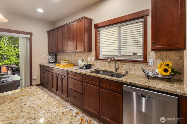 19301 87th Avenue Ct E, Graham, WA 98375 - kitchen with light stone countertops, stainless steel dishwasher, a sink, and tasteful backsplash