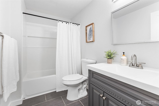 bathroom featuring tile patterned floors, toilet, vanity, and shower / bathtub combination with curtain