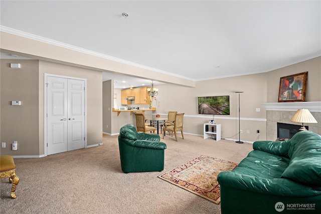 living area with baseboards, ornamental molding, a tiled fireplace, and light carpet