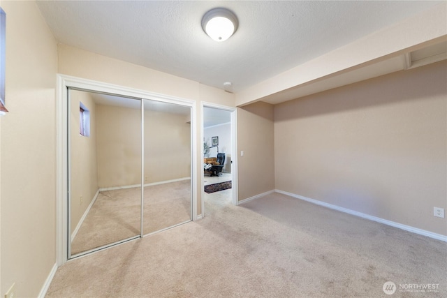 12724 Marine Dr, Anacortes, WA 98221 - unfurnished bedroom featuring baseboards, a closet, and carpet