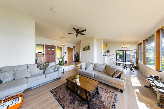 12724 Marine Dr, Anacortes, WA 98221 - living area featuring light wood finished floors and ceiling fan with notable chandelier