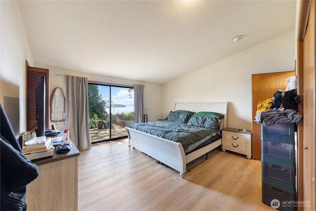12724 Marine Dr, Anacortes, WA 98221 - bedroom with lofted ceiling, light wood finished floors, and access to exterior