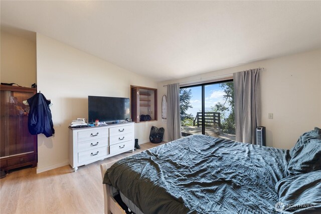 12724 Marine Dr, Anacortes, WA 98221 - bedroom with lofted ceiling, light wood-style flooring, baseboards, and access to outside