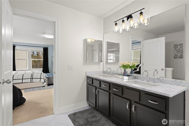 ensuite bathroom featuring a sink, a chandelier, double vanity, and connected bathroom