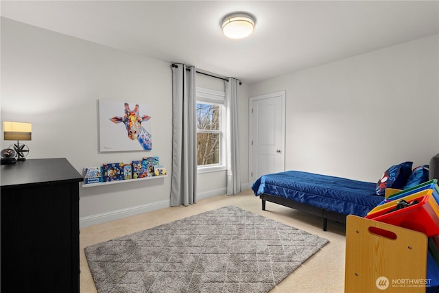 bedroom with baseboards and carpet