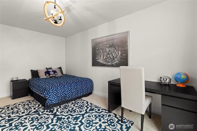 bedroom with baseboards, carpet floors, and a chandelier