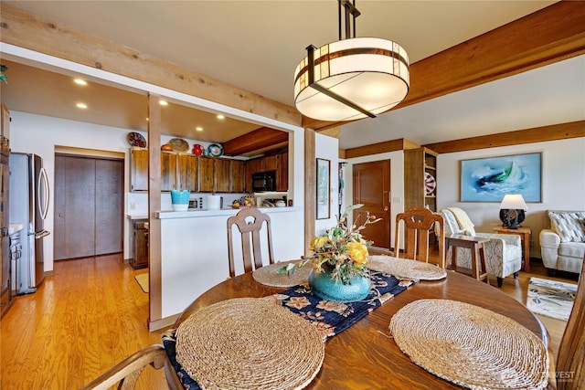dining room featuring beamed ceiling, recessed lighting, and light wood-type flooring
