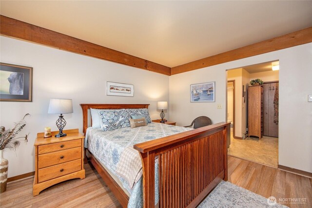 bedroom featuring light wood-style flooring and baseboards