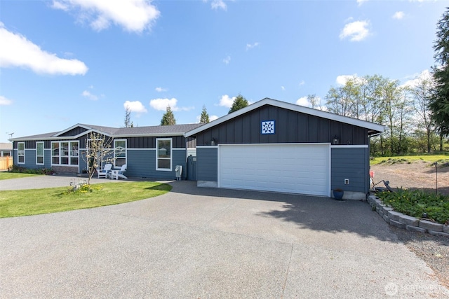 ranch-style home with driveway, board and batten siding, a front lawn, and a garage