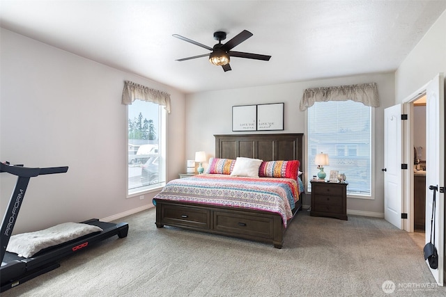 bedroom featuring ceiling fan, light colored carpet, and baseboards