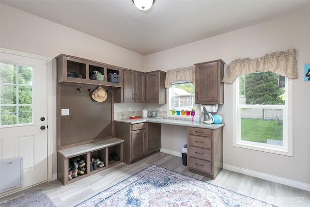 mudroom featuring baseboards and light wood-type flooring