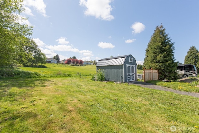 view of yard featuring a storage shed and an outbuilding