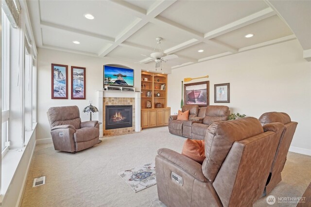 living area featuring light colored carpet, visible vents, coffered ceiling, baseboards, and a fireplace
