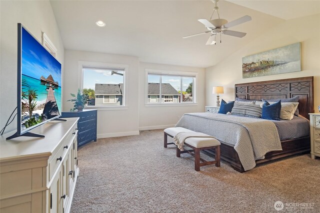 bedroom with a ceiling fan, vaulted ceiling, light carpet, and baseboards