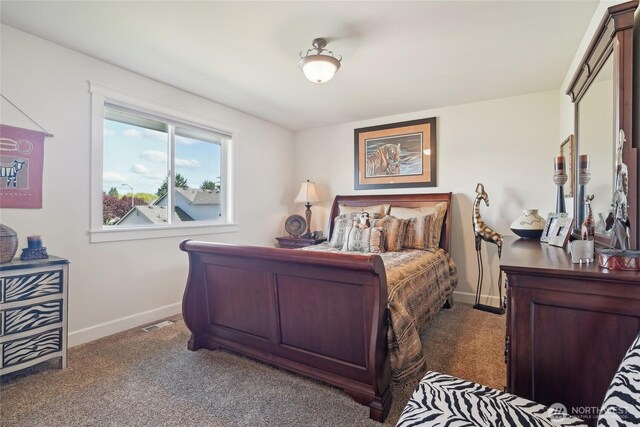carpeted bedroom featuring visible vents and baseboards