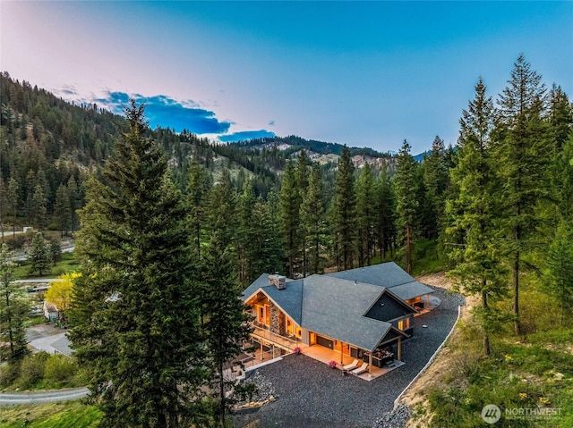 birds eye view of property with a view of trees