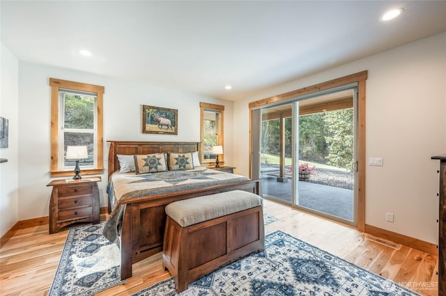 bedroom featuring baseboards, access to exterior, and multiple windows