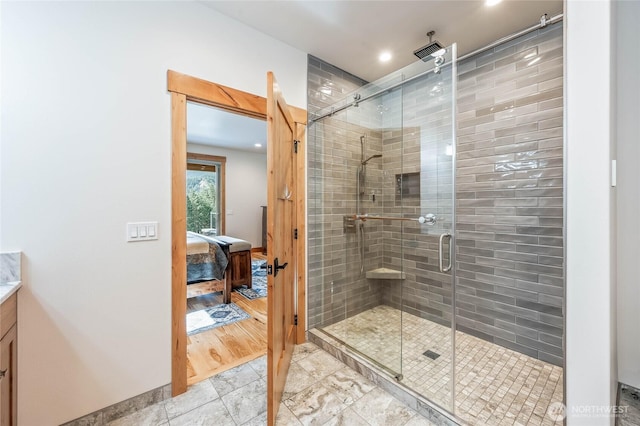ensuite bathroom featuring ensuite bathroom, recessed lighting, and a stall shower