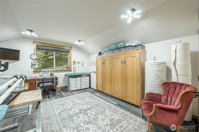 office area featuring light wood finished floors and vaulted ceiling