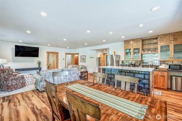 dining space with recessed lighting and light wood-style floors