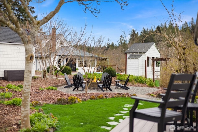 exterior space with a fire pit, a gazebo, an outbuilding, a storage shed, and a yard