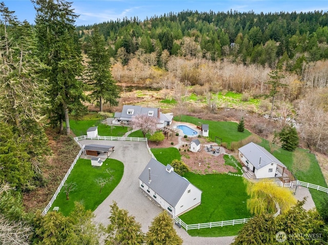 birds eye view of property with a forest view