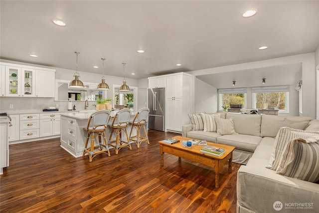 living room featuring dark wood finished floors, recessed lighting, and a wealth of natural light