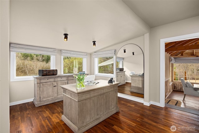 office area featuring baseboards, dark wood-type flooring, and vaulted ceiling